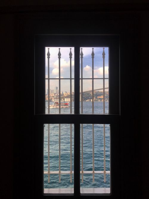 Free İstanbul skyline seen through a window above the sea with boats, creating a framed picturesque view. Stock Photo