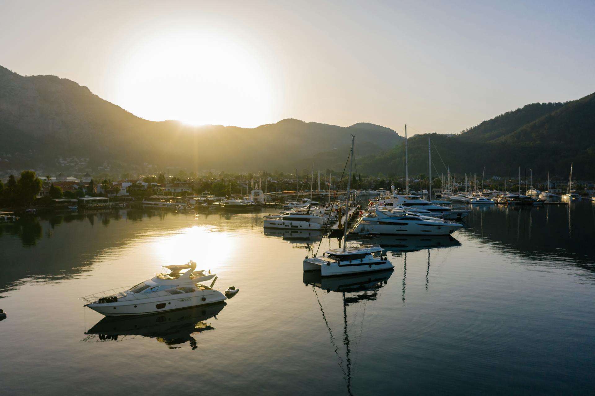 Serene marina with yachts at sunset, perfect for luxury travel and relaxation.