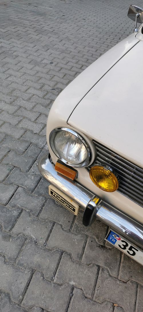 Free Close-up of a vintage car's front bumper and headlights, showcasing retro automotive design. Stock Photo