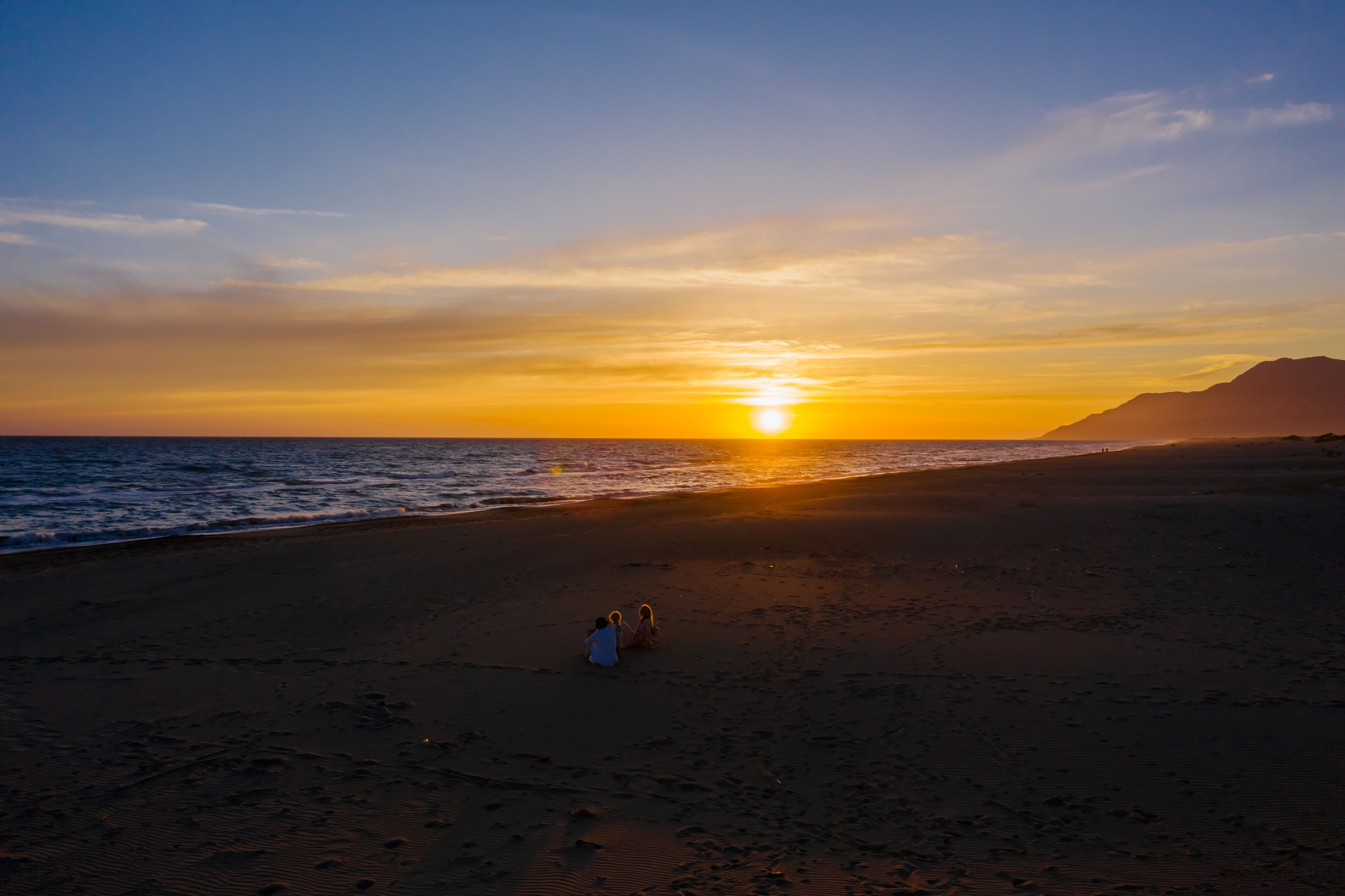 People Sitting on the Beach during Sunset · Free Stock Photo