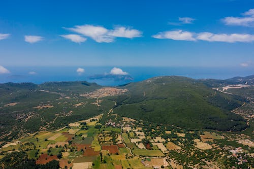 Aerial View of Mountains with Crops in the Valley and Sea in the Background 