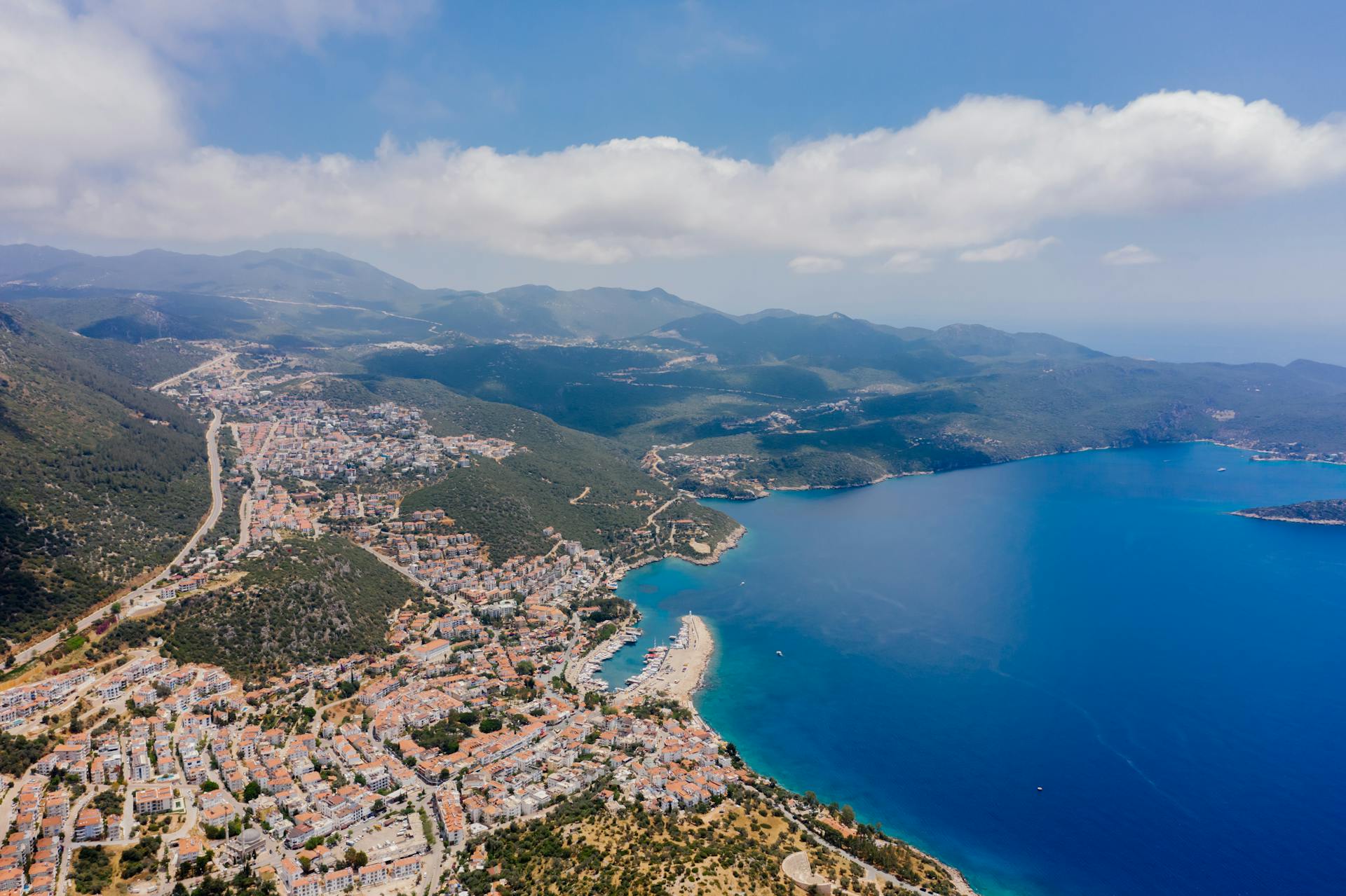 Aerial View of City on a Coast and Mountains