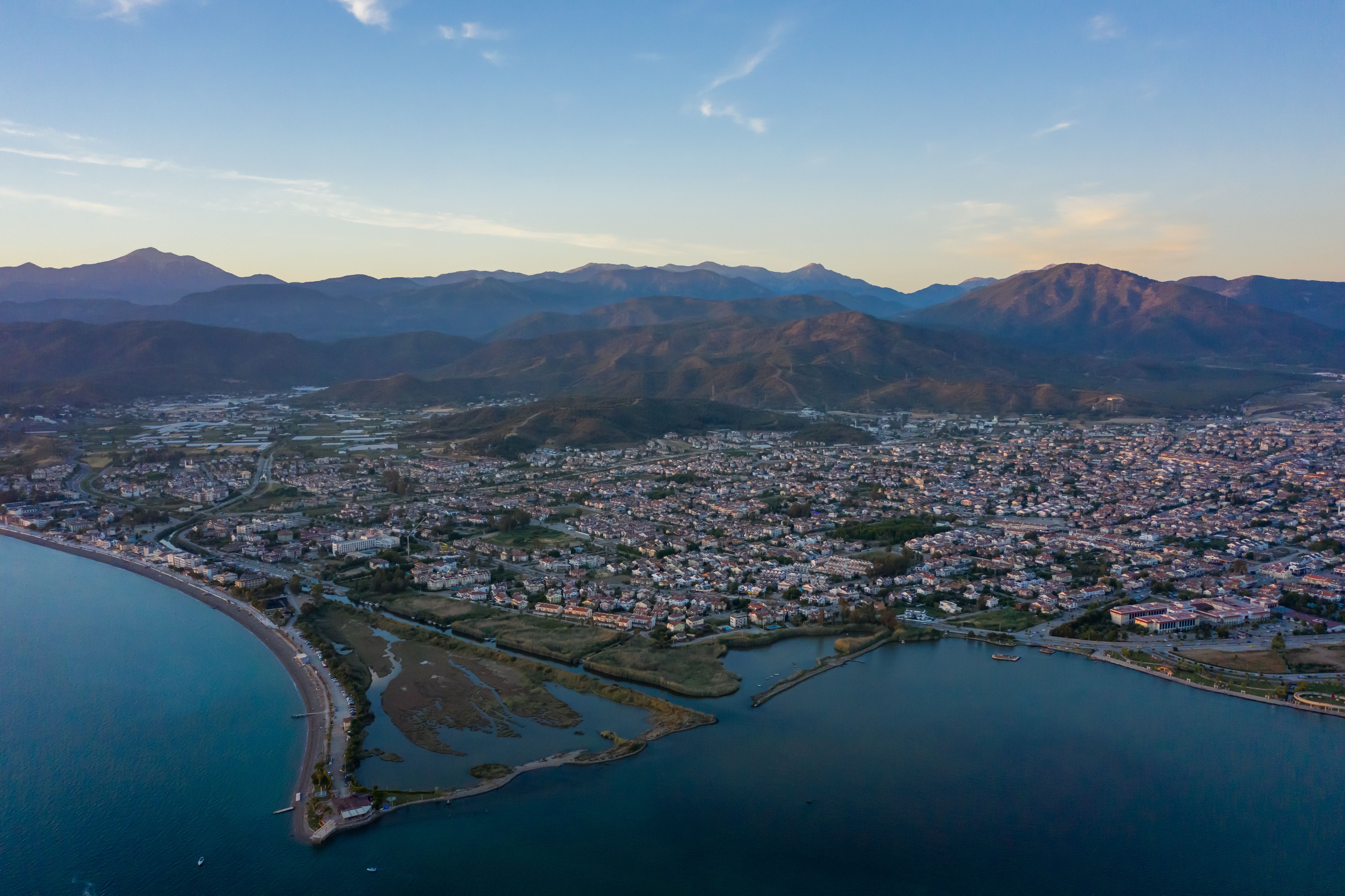 Aerial View of a Coastal City and Mountains in the Horizon · Free Stock ...