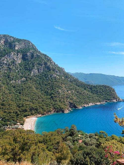 Free Breathtaking aerial photograph of the stunning Fethiye beach with lush green mountains and crystal clear blue waters in Muğla, Türkiye. Stock Photo