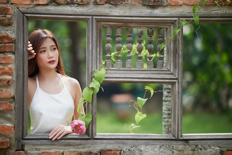 Woman Looking In Wooden Window In Nature