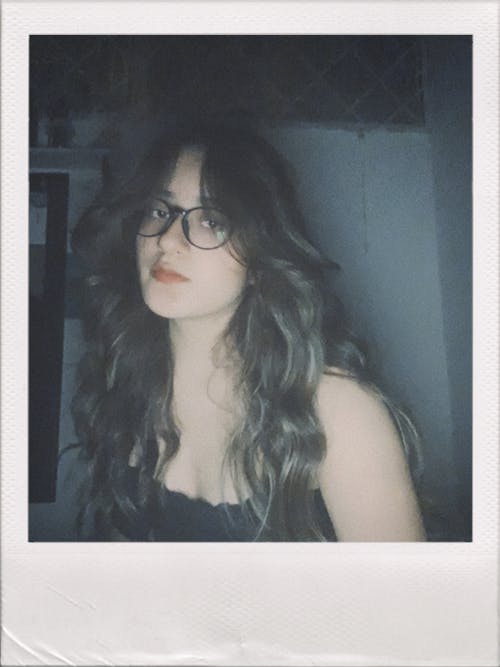 Free Polaroid Picture of a Young Woman with Long Hair Wearing Eyeglasses Stock Photo