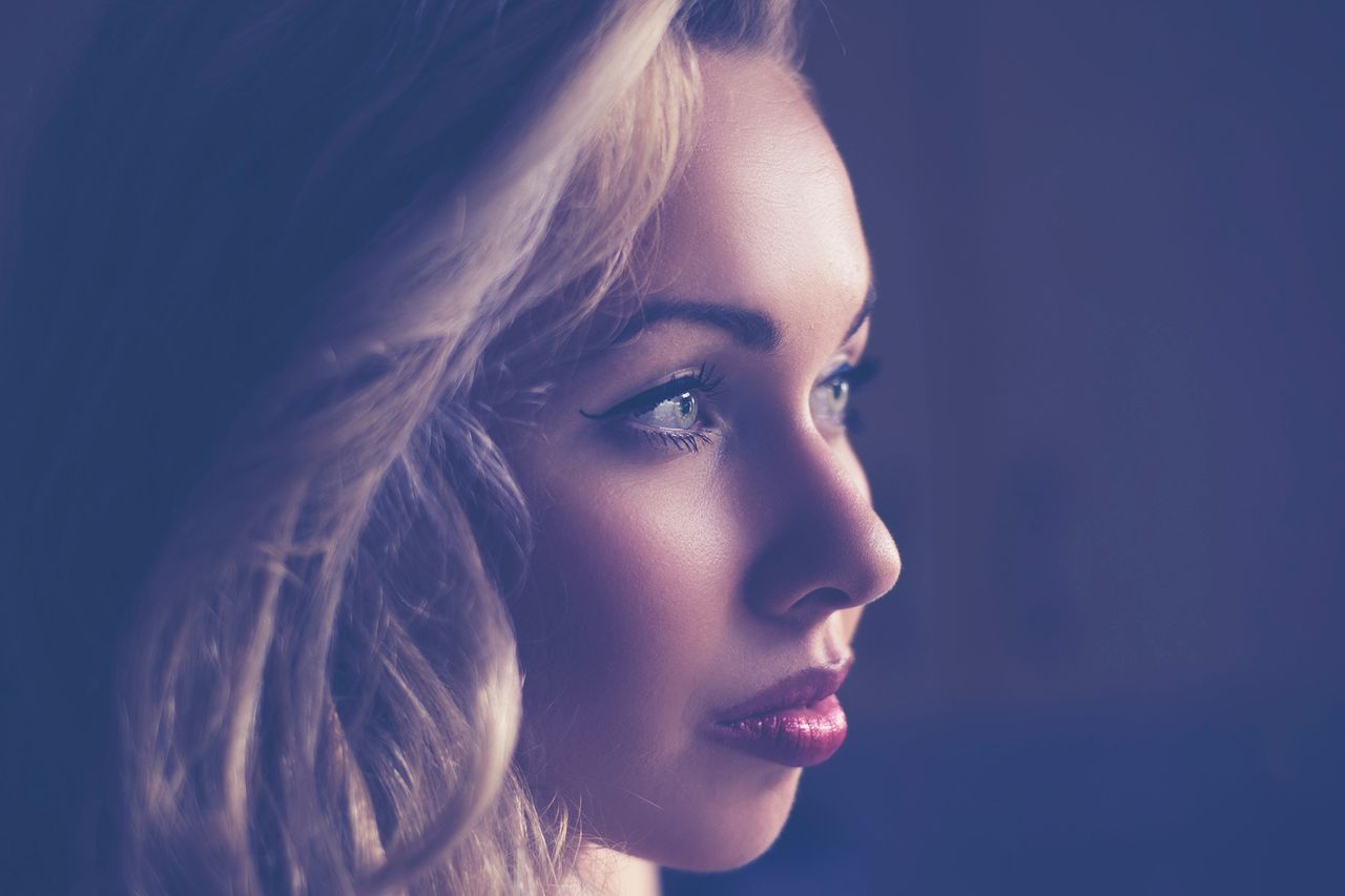 captivating side profile of a young woman with blonde hair expressive