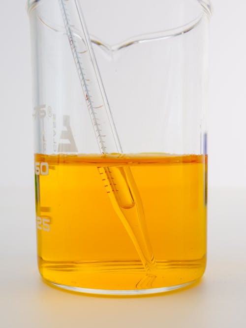 Free Close-Up View of a Yellow Liquid in a Beaker Stock Photo