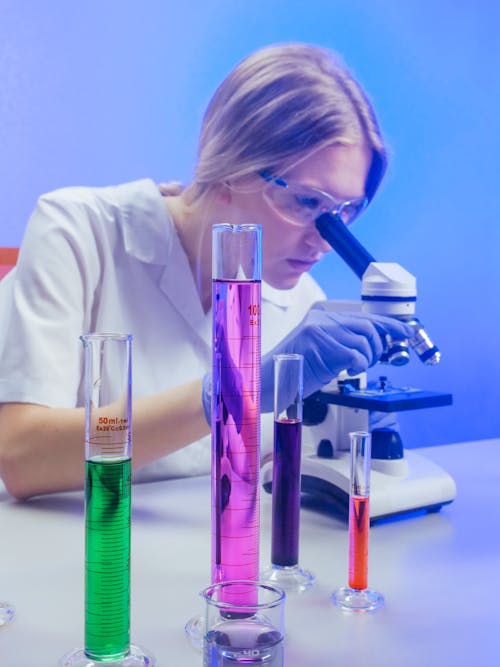 A Woman Examining a Microscope Slide