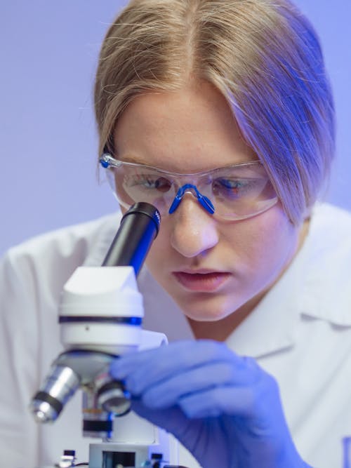 A Woman Examining a Microscope Slide