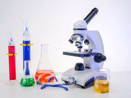 A Microscope and Colorful Liquids in Laboratory Glasswares