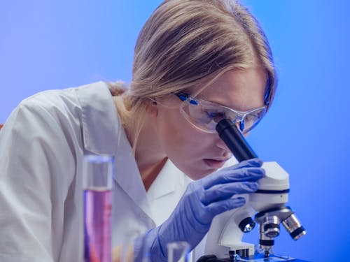 A Woman Examining a Microscope Slide