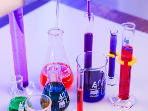 Close-Up View of Laboratory Glasswares and Colorful Chemicals