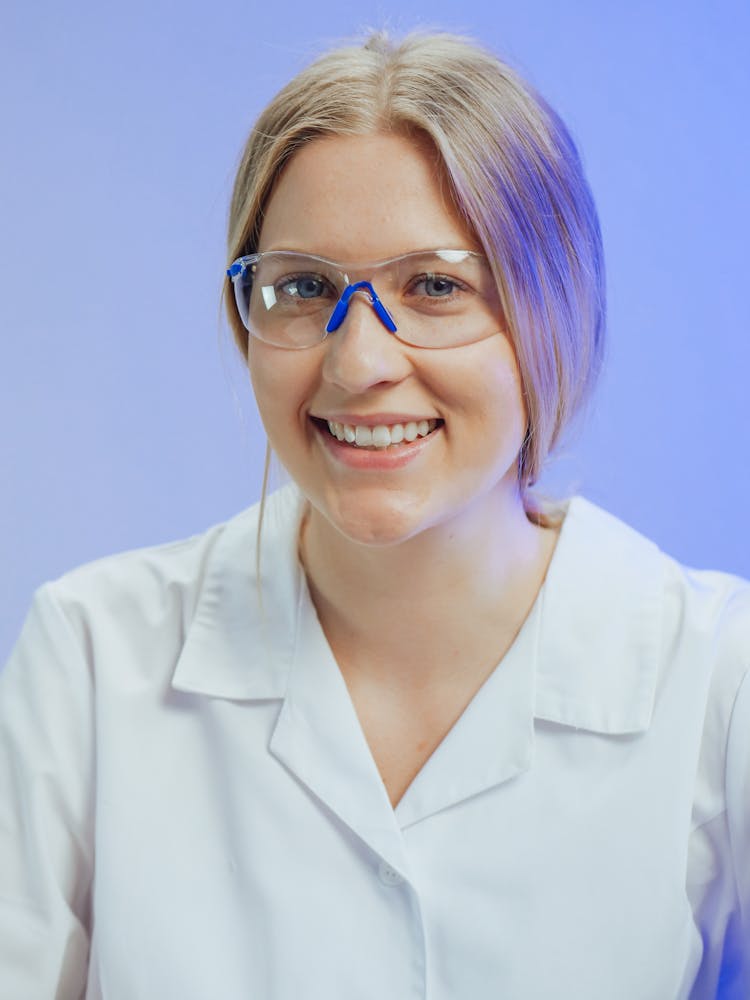 A Woman Wearing Safety Glasses While Smiling