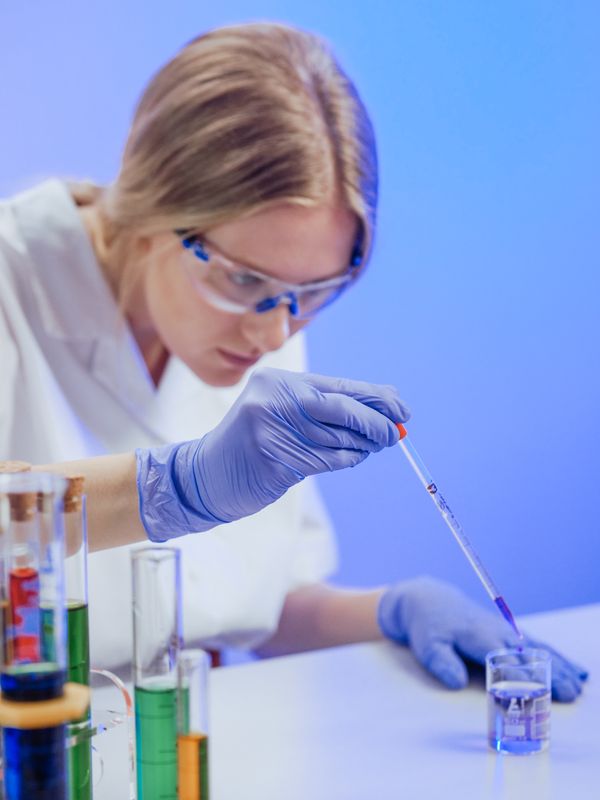 Scientist with pipette, blue lighting