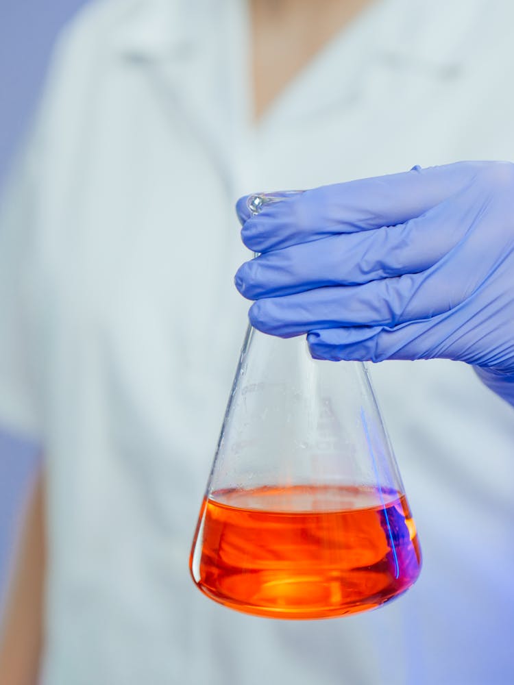 Close-Up Photo Of A Person Holding An Erlenmeyer Flask