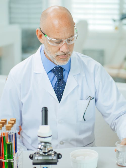 Man in White Coat Doing an Experiment