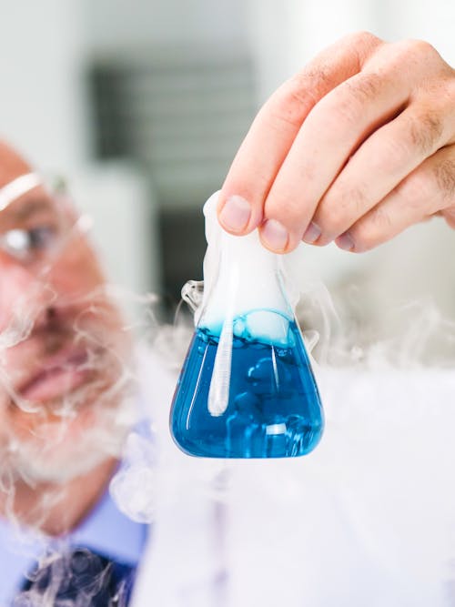 Free Close-Up View of a Person Holding an Erlenmeyer Flask Stock Photo
