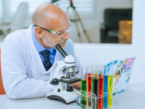 Man in White Coat Doing an Experiment