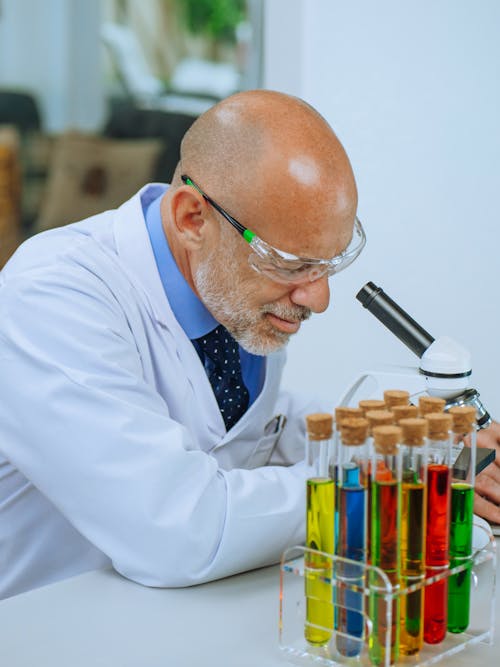 A Man Examining a Microscope Slide