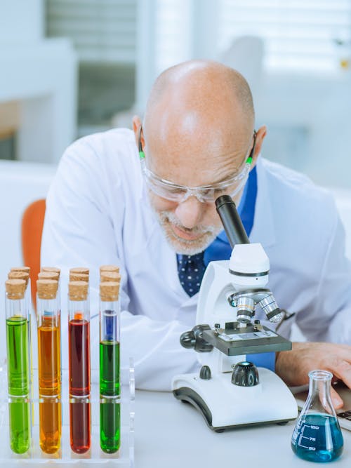 A Man Examining a Microscope Slide