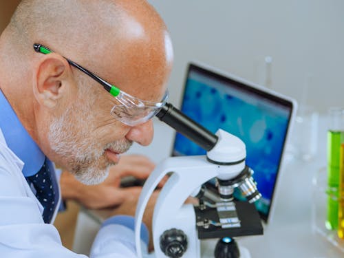 A Man Examining a Microscope Slide