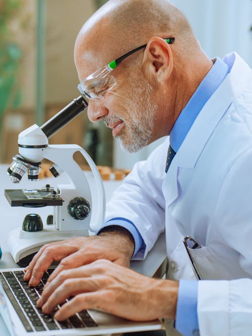 A Man Examining a Microscope Slide