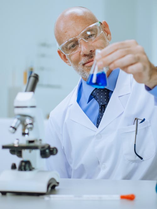 A Man in White Coat Doing an Experiment