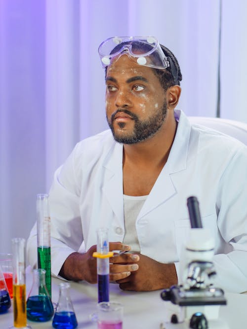 Free Man in White Coat Doing an Experiment Stock Photo