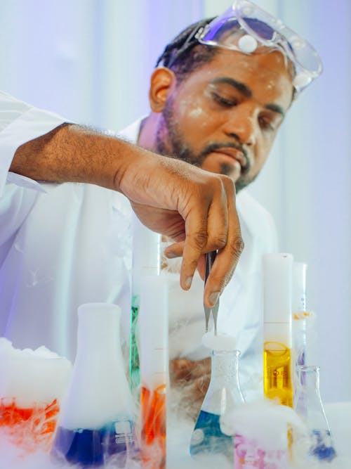Man in White Coat Doing an Experiment