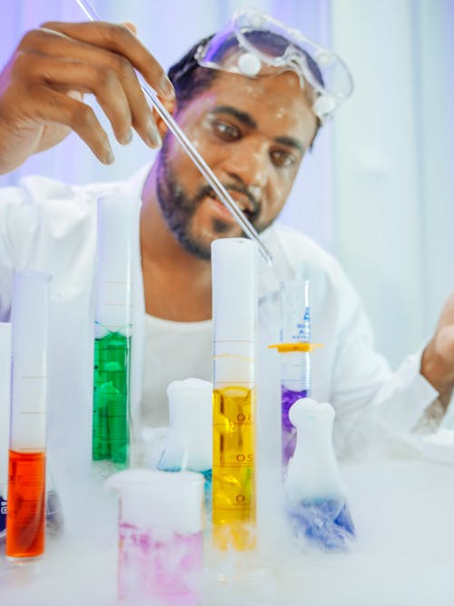 Man in White Coat Doing an Experiment