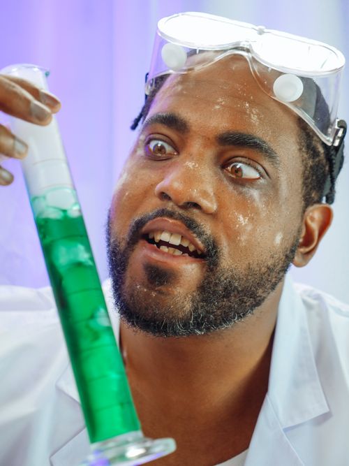 Free Excited scientist analyzing a chemical reaction in the laboratory with green liquid. Stock Photo