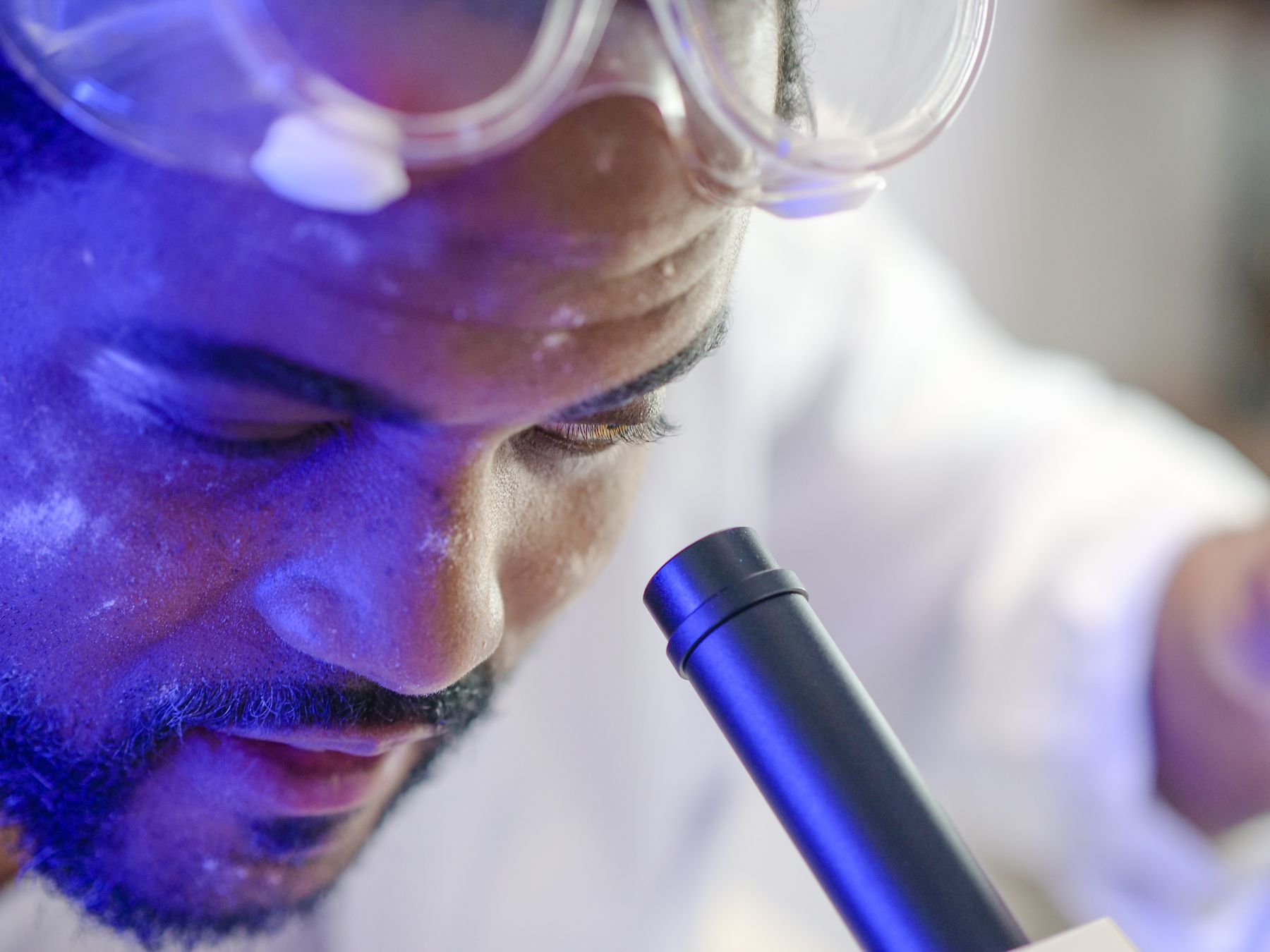 Researcher at a microscope