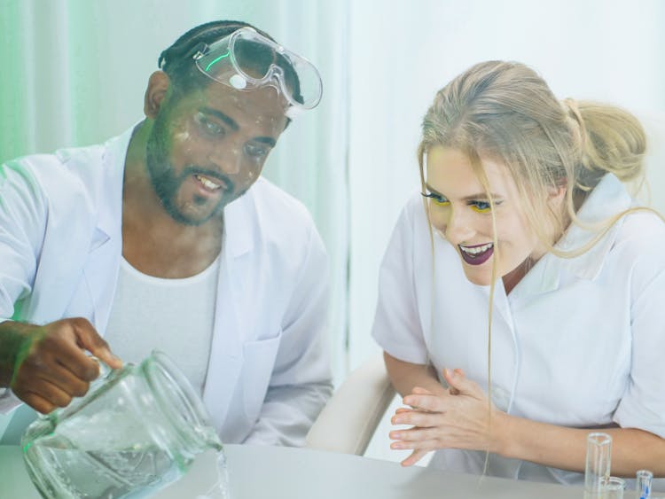 Man And Woman In White Coat Doing An Experiment