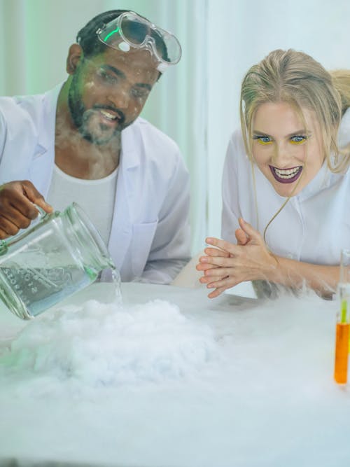 Man and Woman in White Coat Doing an Experiment