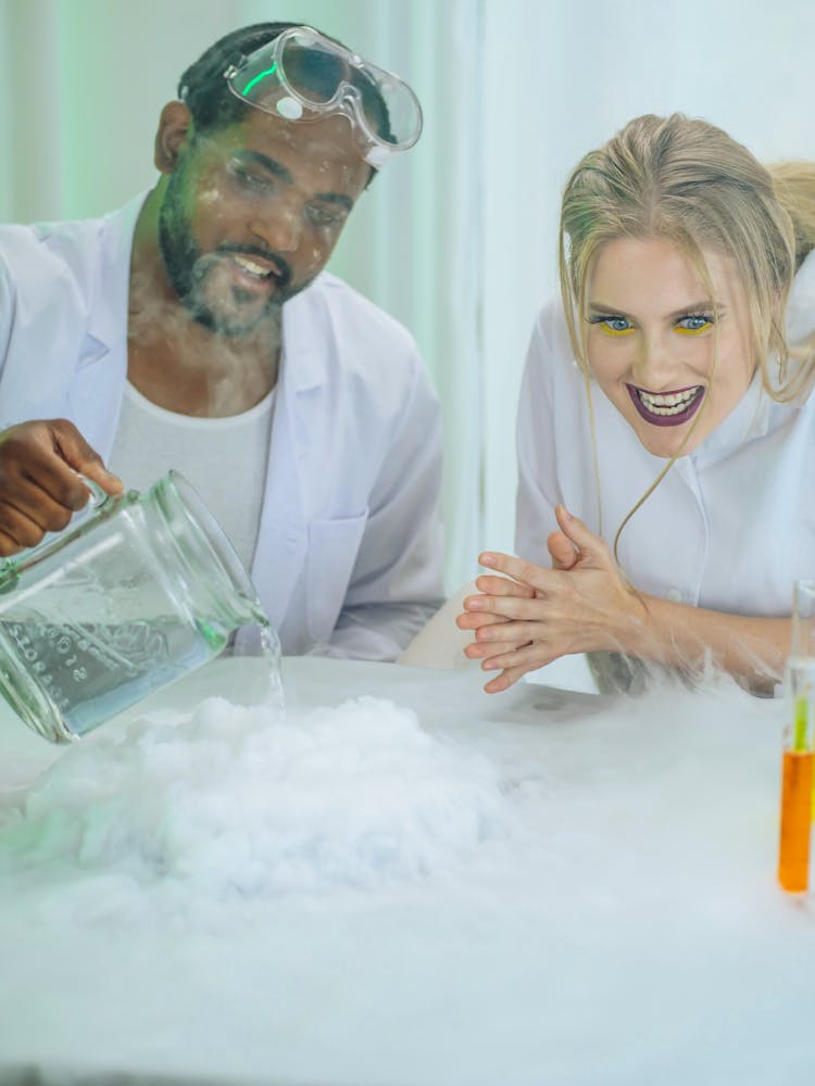 Man And Woman In White Coat Doing An Experiment