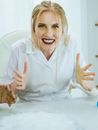 Woman in White Coat Looking Excited