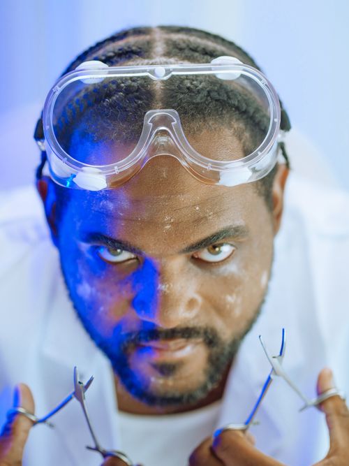 Free Focused scientist with protective goggles in a lab setting, conveying intensity and passion. Stock Photo