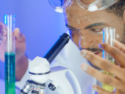 Free Close-Up View of a Man Looking into the Microscope Stock Photo