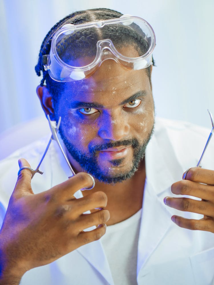 Man In White Coat Holding Forceps