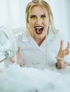 Woman in White Coat Looking Excited