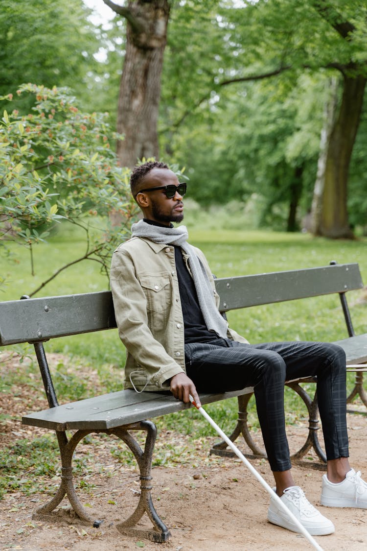 A Blind Man Sitting On A Bench