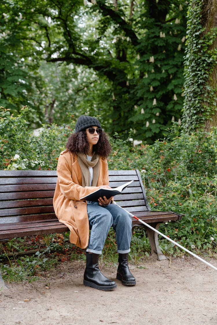 A Blind Woman Sitting On The Bench