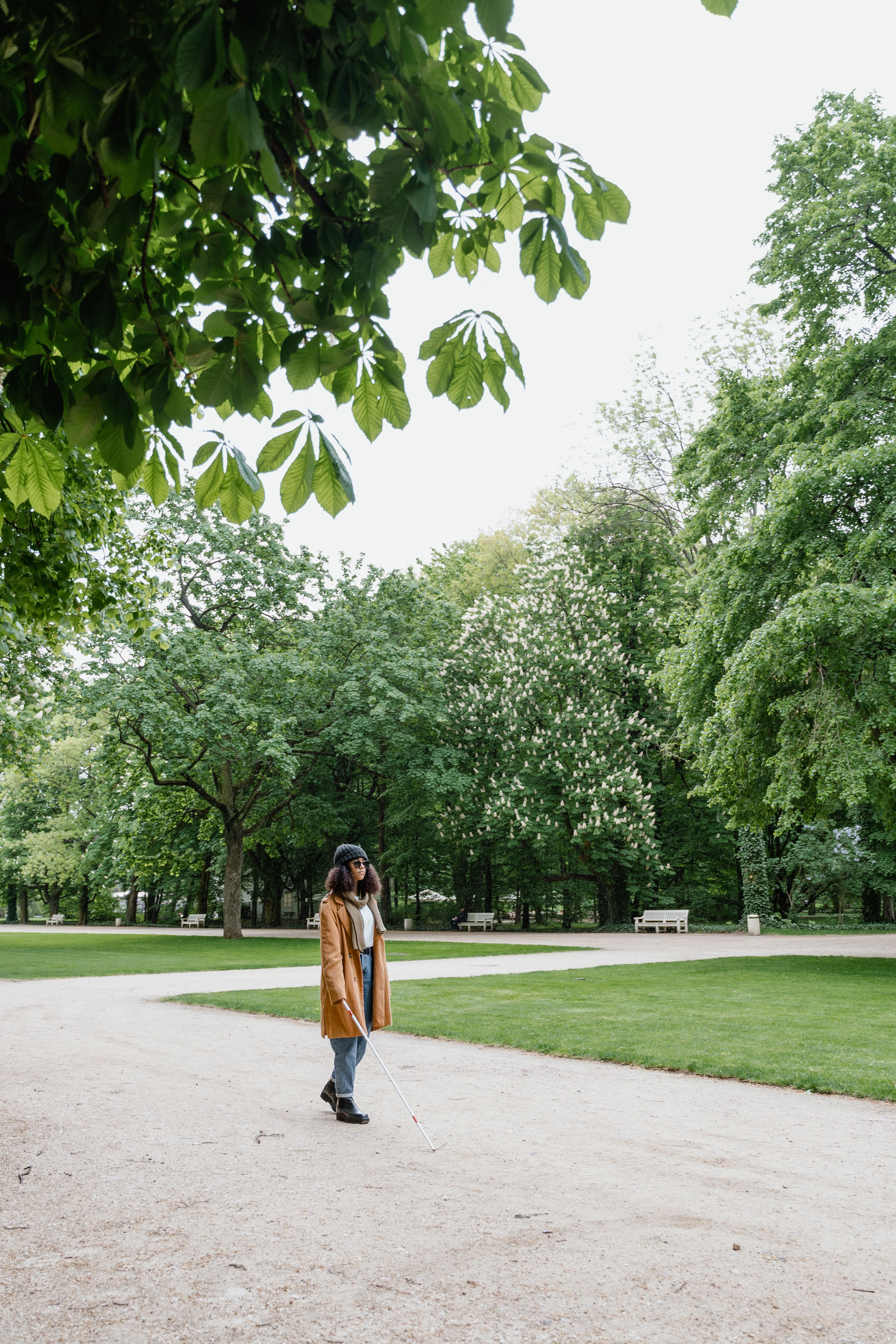 Woman Wearing a Brown Coat Walking at a Park · Free Stock Photo