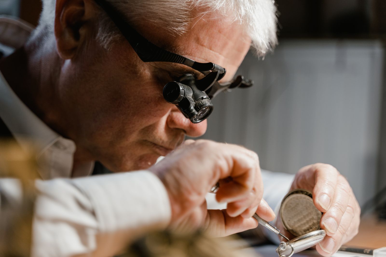 Watchmaker working with a loupe at the bench, photo by Tima Miroshnichenko on Pexels