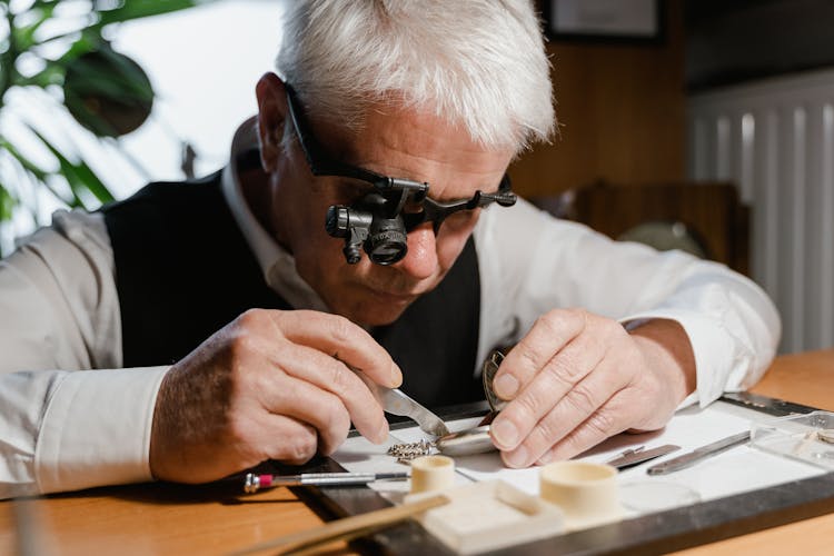 A Man Repairing A Pocket Watch 