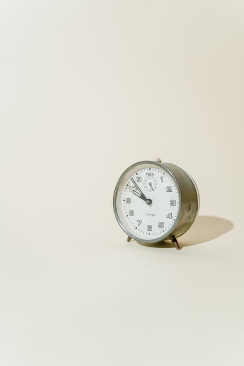 Free An Alarm Clock on a White Surface Stock Photo