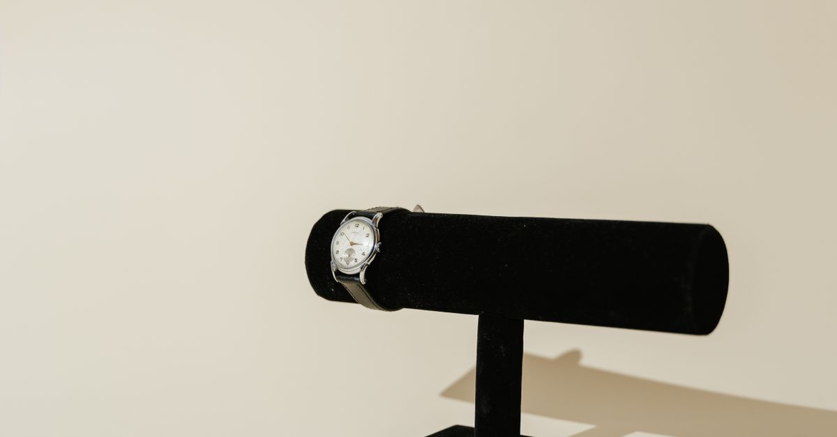 Black Leather Strap Watch on a Rack · Free Stock Photo