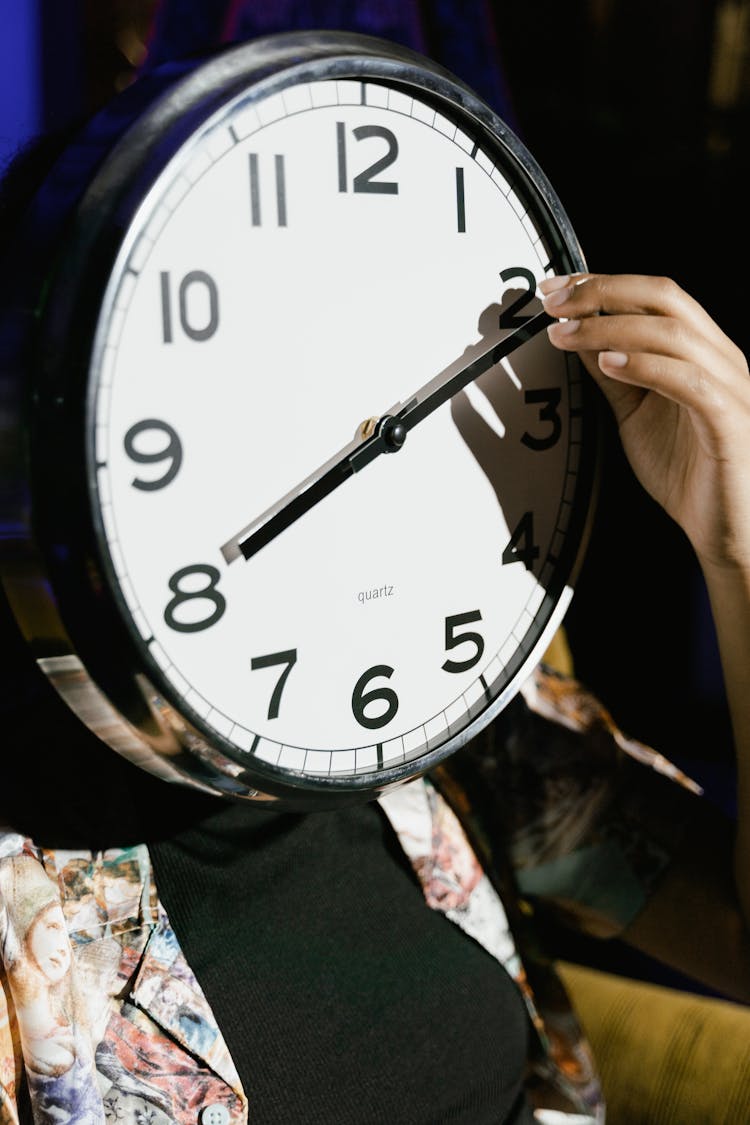 Hand Holding The Hand Of A Clock 