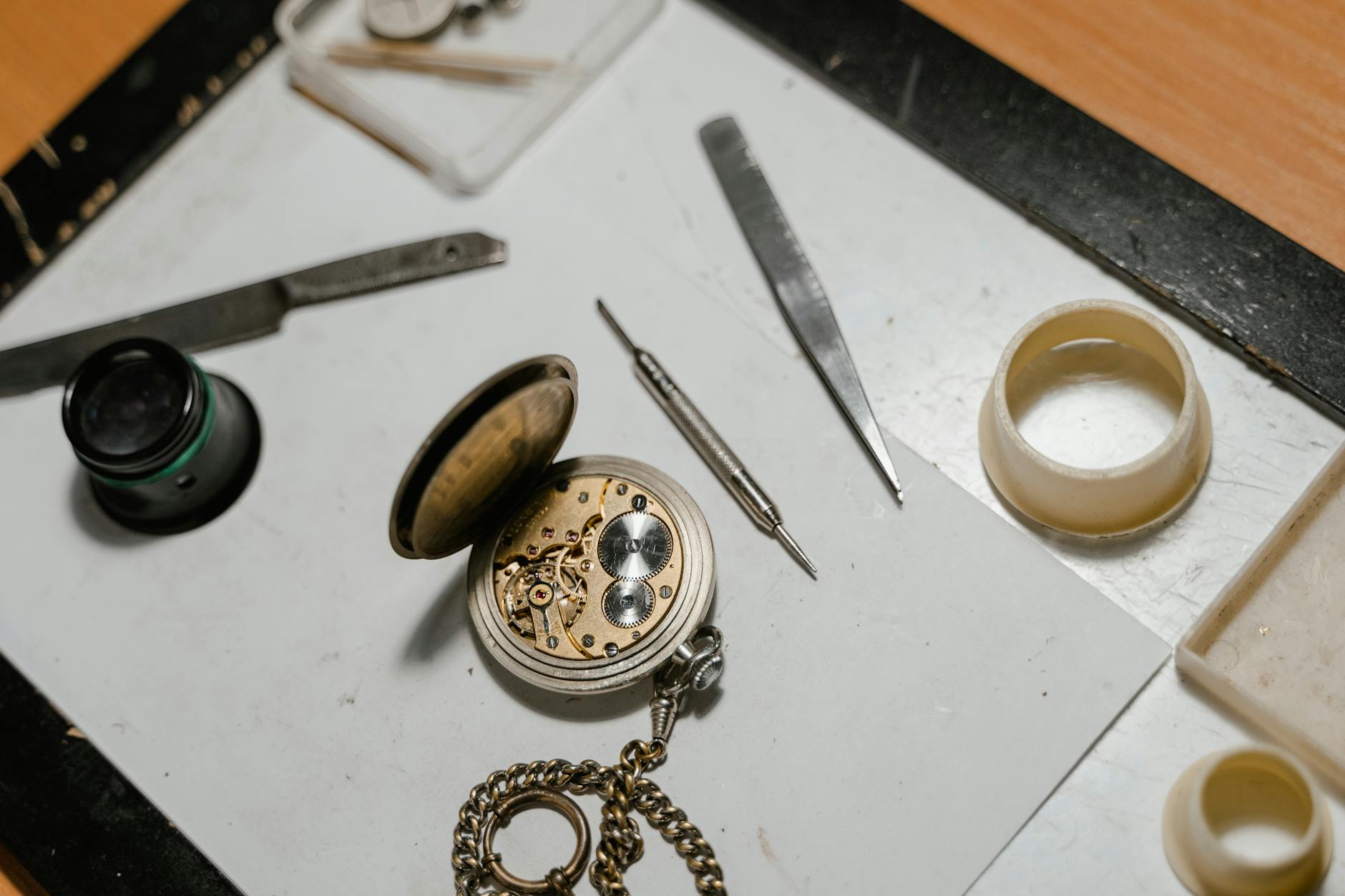 Stainless Steel Tools Beside an Opened Pocket Watch